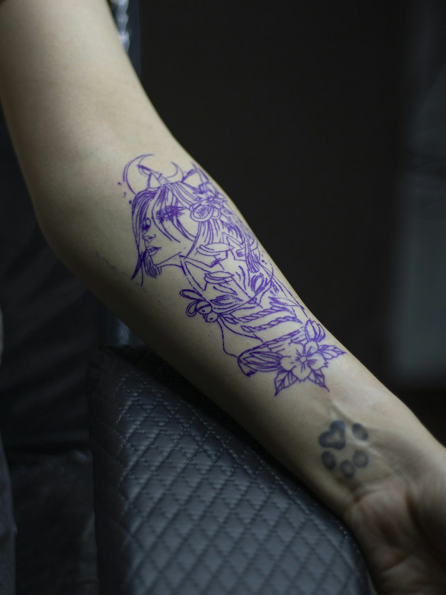 A faded tattoo covered with blackwork — Before